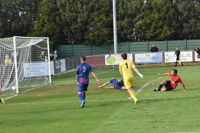 Fareham's Curt Robbins, right, fires home the first of his three goals against US Portsmouth. Picture: Paul Proctor