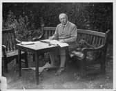Portrait of Sir Arthur Conan Doyle sitting at a table in his garden, Bignell Wood, New Forest, 1927. (Photo by Fox Photos/Hulton Archive/Getty Images)