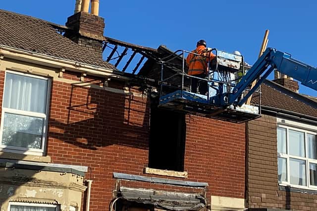 Demolition crews inspect the destroyed home in Nelson Avenue, North End. Photo: Tom Cotterill