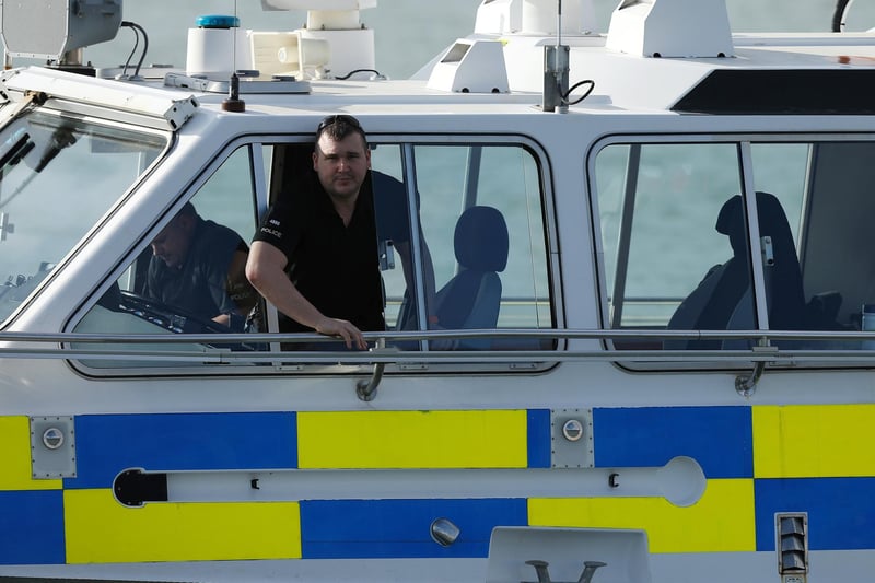 Police officer who kindly notified the waiting public and the The News' photographer that, "She's not going today, she's going tomorrow." Departure of HMS Prince of Wales is postponed, Old Portsmouth
Picture: Chris Moorhouse (jpns 110224-04)