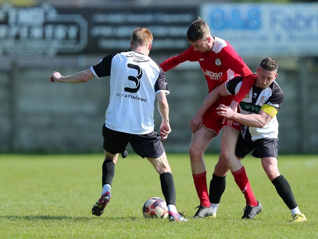 Horndean's Harry Jackson (red) is closely marked. Picture: Chris Moorhouse