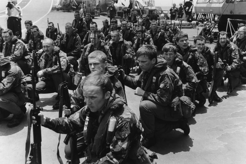 Royal Marines waiting on the flight deck of HMS Hermes for Sea King helicopters to take them on training manoeuvres, April 1982.