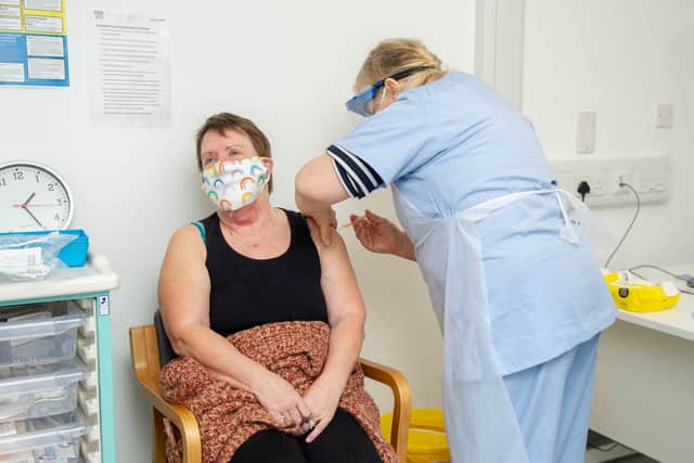Retired GP Wendy Peters gives Jackie Blake a vaccination jab at St James' Hospital in Portsmouth in February - now volunteers from Portsmouth are wanted to help with a vaccine booster trial 
Picture: Habibur Rahman