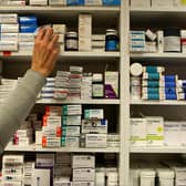 A pharmacist stocks shelves at a chemist. Photo: PA