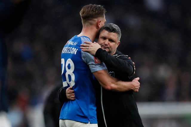 Caretaker boss Simon Bassey embraces Michael Morrison following Pompey's admirable 1-0 defeat at Premier League Spurs in the FA Cup. Picture: IAN KINGTON/AFP via Getty Images
