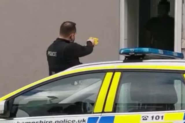 A police officer was recorded firing a Taser device at a man in North End. Pictured is the barb in flight before it hits the male.