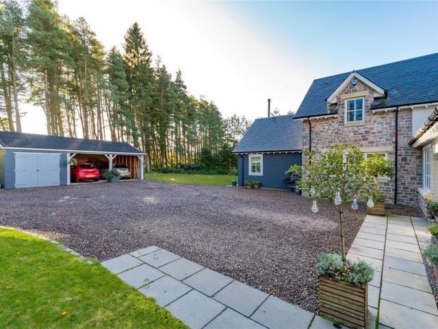 Drive and parking area in front of house.