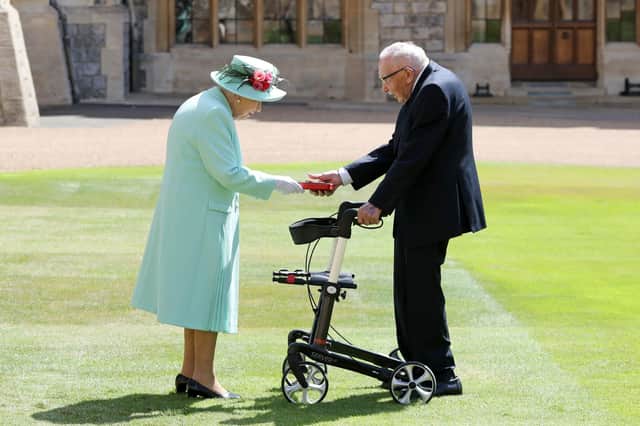 Captain Sir Thomas Moore receiving his knighthood from Queen Elizabeth II. Picture: Chris Jackson/PA Wire