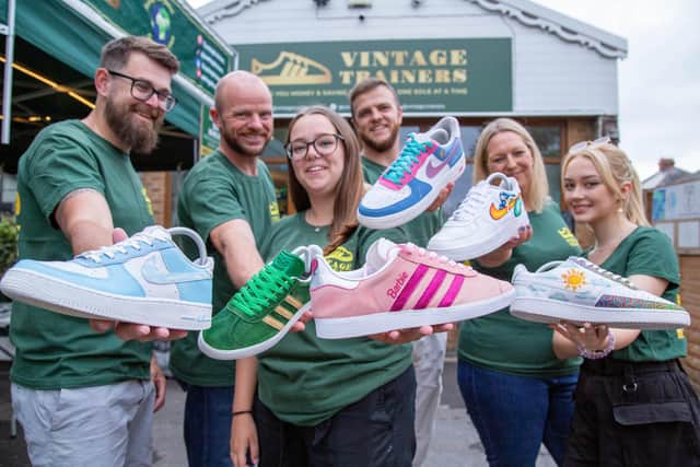 Staff with the remade shoes outside the Vintage Trainers shop
Picture: Habibur Rahman