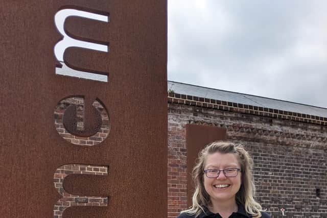 Felicity Wood, public participation officer at The D-Day Story, next to the memorial wall. Picture: Emily Turner