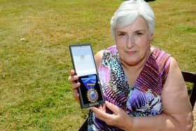 Sylvia Simmons, 70,  with her Royal College of Nursing Award of Merit. Picture: Sarah Standing (180544-8527)