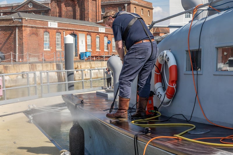 Keeping the decks clean in Portsmouth Harbour. Picture: Mike Cooter (08042023)