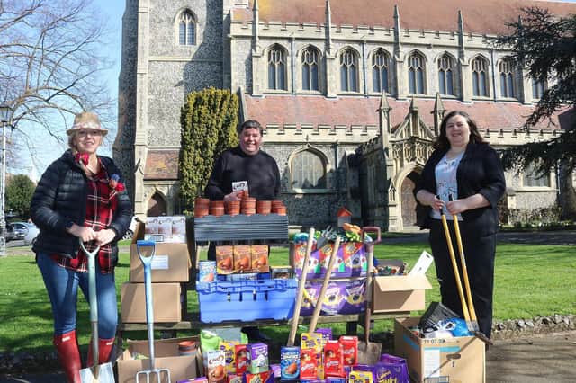 Mel Goddard, family services manager at the Roberts Centre, and Jo Eamey, business support and development director at Stop Domestic Abuse, receiving the Easter donations from Canon Bob White, vicar at St Mary's Church in Fratton