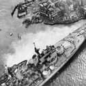 Horrified spectators flock to see the HMS Vanguard aground in Portsmouth Harbour, 1960. The News PP5336