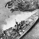 Horrified spectators flock to see the HMS Vanguard aground in Portsmouth Harbour, 1960. The News PP5336