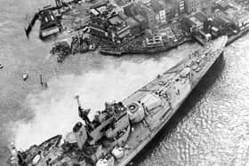 Horrified spectators flock to see the HMS Vanguard aground in Portsmouth Harbour, 1960. The News PP5336