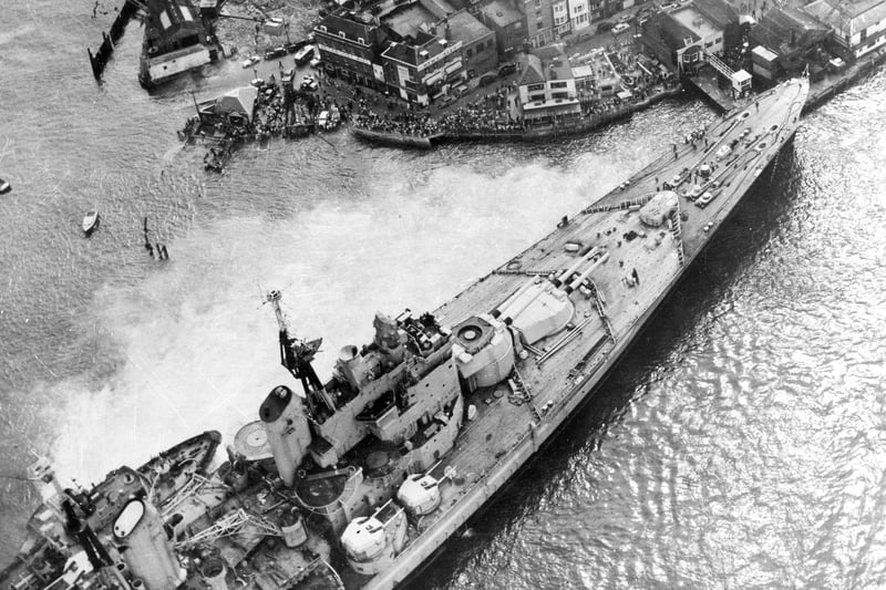 Horrified spectators flock to see the HMS Vanguard aground in Portsmouth Harbour, 1960. The News PP5336