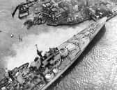 Horrified spectators flock to see the HMS Vanguard aground in Portsmouth Harbour, 1960. The News PP5336