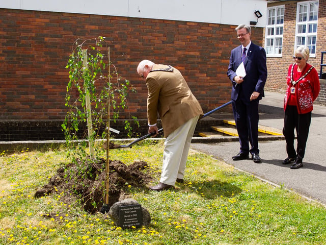 Mayor Councillor Peter Wade planting a tree to commemorate the school's 100th anniversary