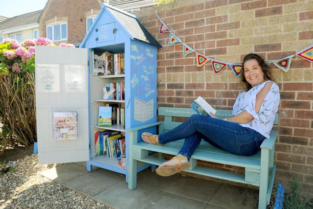 Sarah Kirby from Camelia Close in Denvilles, and her daughters set up a box at the end of their driveway during lockdown for neighbours to take books from, and through a fundraiser they have managed to create a permanent lockdown library at the end of the road with a bench and a community herb garden.Picture: Sarah Standing (060820-2173)