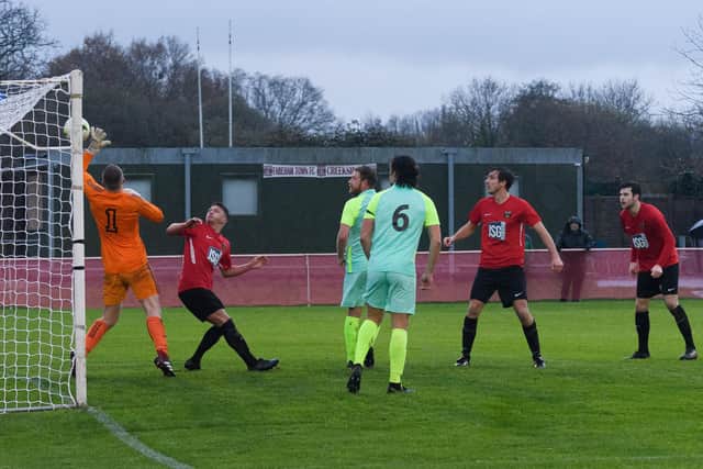 Curt Robbins, second right, watches his header fly into the net for Fareham's second goal against Roman Glass. Picture: Keith Woodland