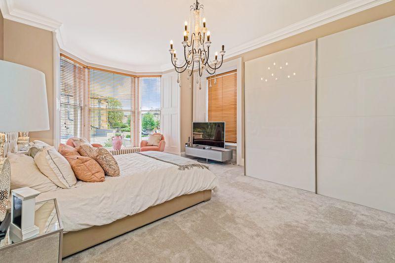 Bedroom 2 has a bay window overlooking the rear garden and additional window to side, as well as fitted wardrobes and an en-suite/dressing room.
