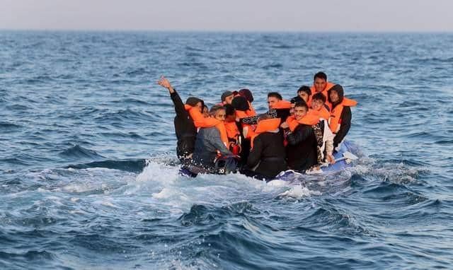 A group of people thought to be migrants crossing the Channel in a small boat headed in the direction of Dover, Kent. Picture by Gareth Fuller/PA