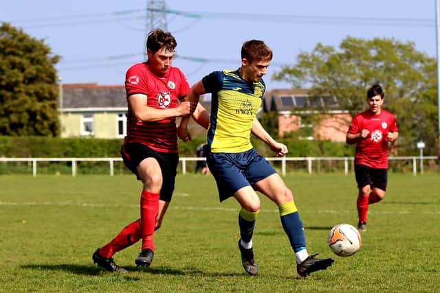 Danny Burroughs (yellow) on the ball for Moneyfields at  Locks Heath. Picture by Tom Phillips