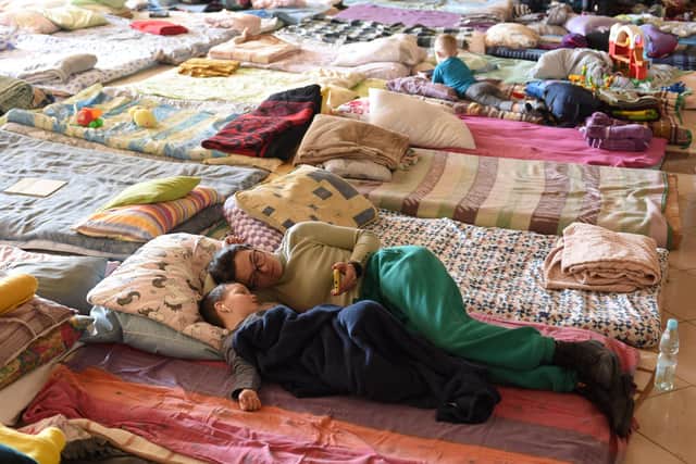 HOMELESS: People rest in a special room for refugees at a railway station in Lviv, western Ukraine. Picture: Yuriy Dyachyshyn / AFP/Getty Images