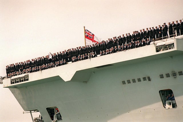 Crew of HMS Invincible line the decks as she sails into Portsmouth in 1999. Picture: Pete Langdown
