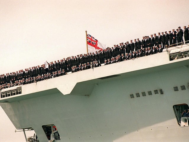 Crew of HMS Invincible line the decks as she sails into Portsmouth in 1999. Picture: Pete Langdown
