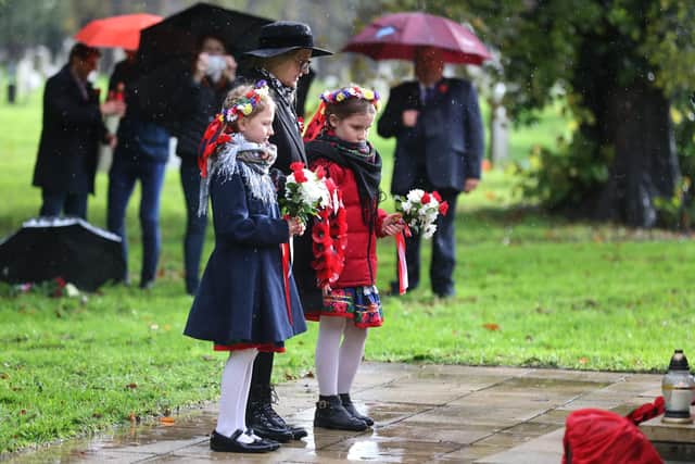 People of all ages gathered at Kingston Cemetery to mark the occasion. Picture: Sam Stephenson.