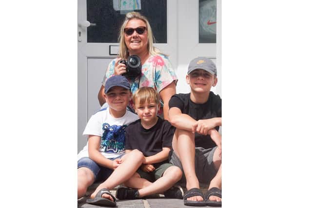 Photographer Sophia Benham from North End has been capturing images of families during lockdown as part of her #atourfrontdoor project to raise money for domestic abuse charity Aurora New Dawn. Pictured: Sophia with sons Rex, Kit and Beau Benham Wyatt, who have been helping along the way