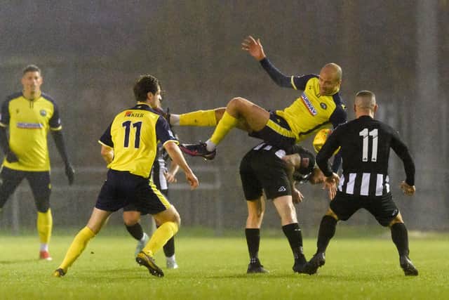 Josh Huggins hitches a ride on the back of a Dorchester player.
Picture: Keith Woodland