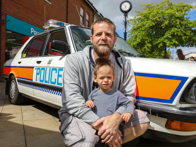 Jake Barrow and his son, Shawn, 18 months, next to a BMW 5 Series police car from the mid 1980s. Picture: Chris  Moorhouse (220624-03)