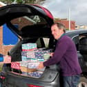 Terry Dowland and Bob Mussellwhite load shoeboxes to be shipped overseas at the Rotary Club of Fareham's Wheel House community building at Hill Head.