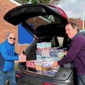 Terry Dowland and Bob Mussellwhite load shoeboxes to be shipped overseas at the Rotary Club of Fareham's Wheel House community building at Hill Head.