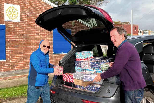 Terry Dowland and Bob Mussellwhite load shoeboxes to be shipped overseas at the Rotary Club of Fareham's Wheel House community building at Hill Head.