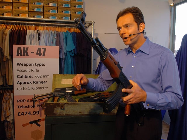 Actor and presenter Geoff Cotton does a piece to camera posing as a telesalesman taking orders for AK-47s - also known as Kalashnikovs - at Million Headed Monster in Albert Road, Southsea in March 2006 (060958-25)