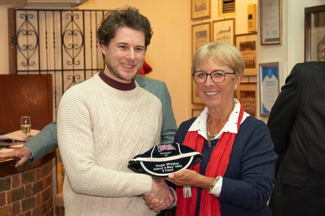 James Midgley collects his late father Roger Midgley's cap from Sheila Monroe. Picture: Keith Woodland