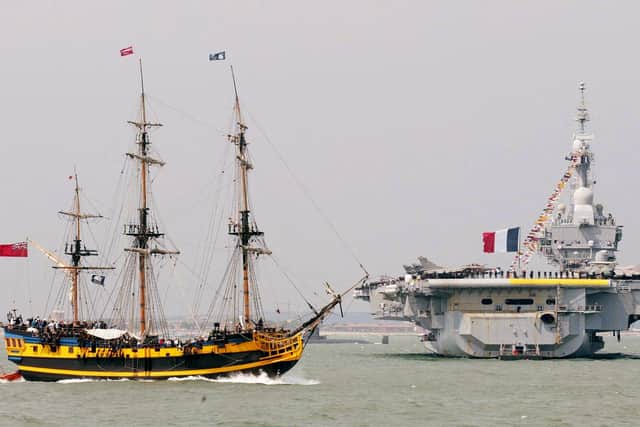 Tall ship The Grand Turk French aircraft carrier FS Charles de Gaulle during the fleet review Picture: Gareth Fuller/PA