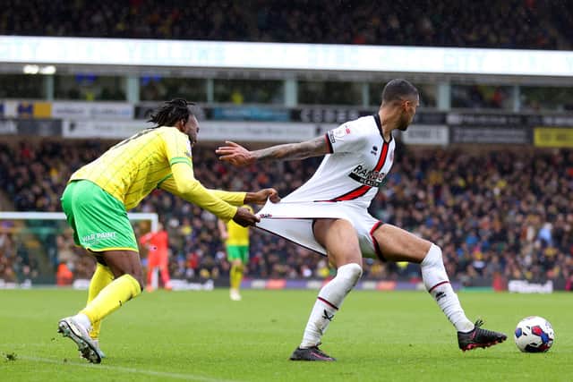 Abu Kamara tries to get to grips with Sheffield United's Max Lowe in Championship action in April. Picture: Stephen Pond/Getty Images