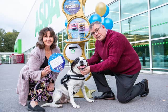 Scratchcard winners Patrick and Paula Morling with their dog Ollie outside Asda in Havant. Picture: James Robinson/Camelot/ National Lottery