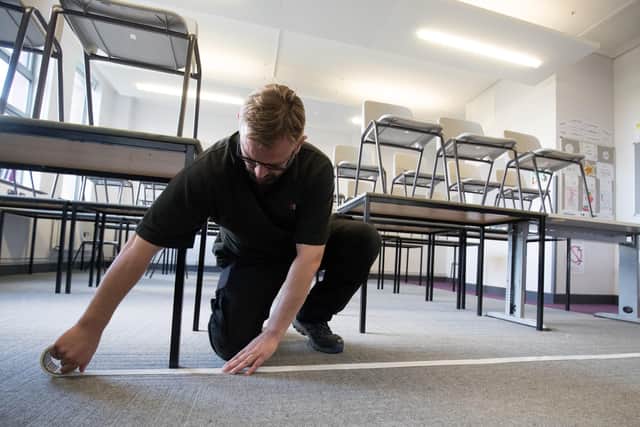 A boundary line to separate pupils from the teacher is taped to the floor in a classroom at Ark Charter Academy in Portsmouth. 

Photo: Andrew Matthews/PA Wire