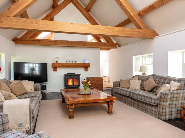 The open plan sitting room benefits from the sun room on one side and clever use of roof lights and windows, the whole wing is flooded with natural light