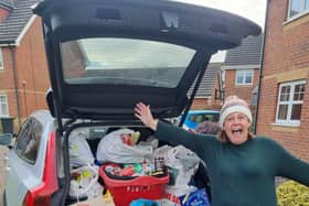 Susan Bonnar with one of the full cars of essentials for the Basics Bank.