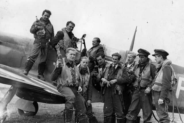 Pilots from a Spitfire squadron, who had just returned from a post-D-Day attack in Normandy, holding bottles of wine. The picture was taken on June 29, 1944. Picture: Getty