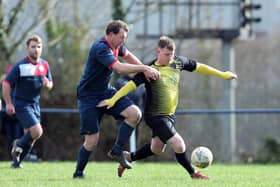 Infinity striker Jamie White, right, is tackled during his side's Hampshire Premier League game at Paulsgrove last month. Picture: Chris Moorhouse