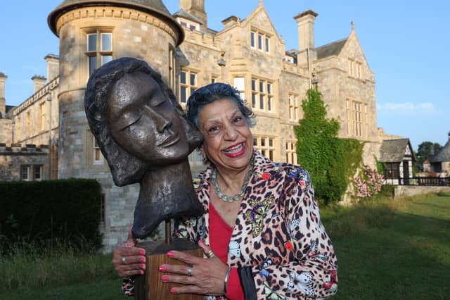 Sculptor Kay Singla pictured with her artwork Dreams on display in front of Palace House