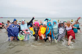 People take part in the Gosport New Year's Day Dip in The Solent at Stokes Bay, Gosport, Hampshire, to raise money for Gosport and Fareham Inshore Rescue Service.